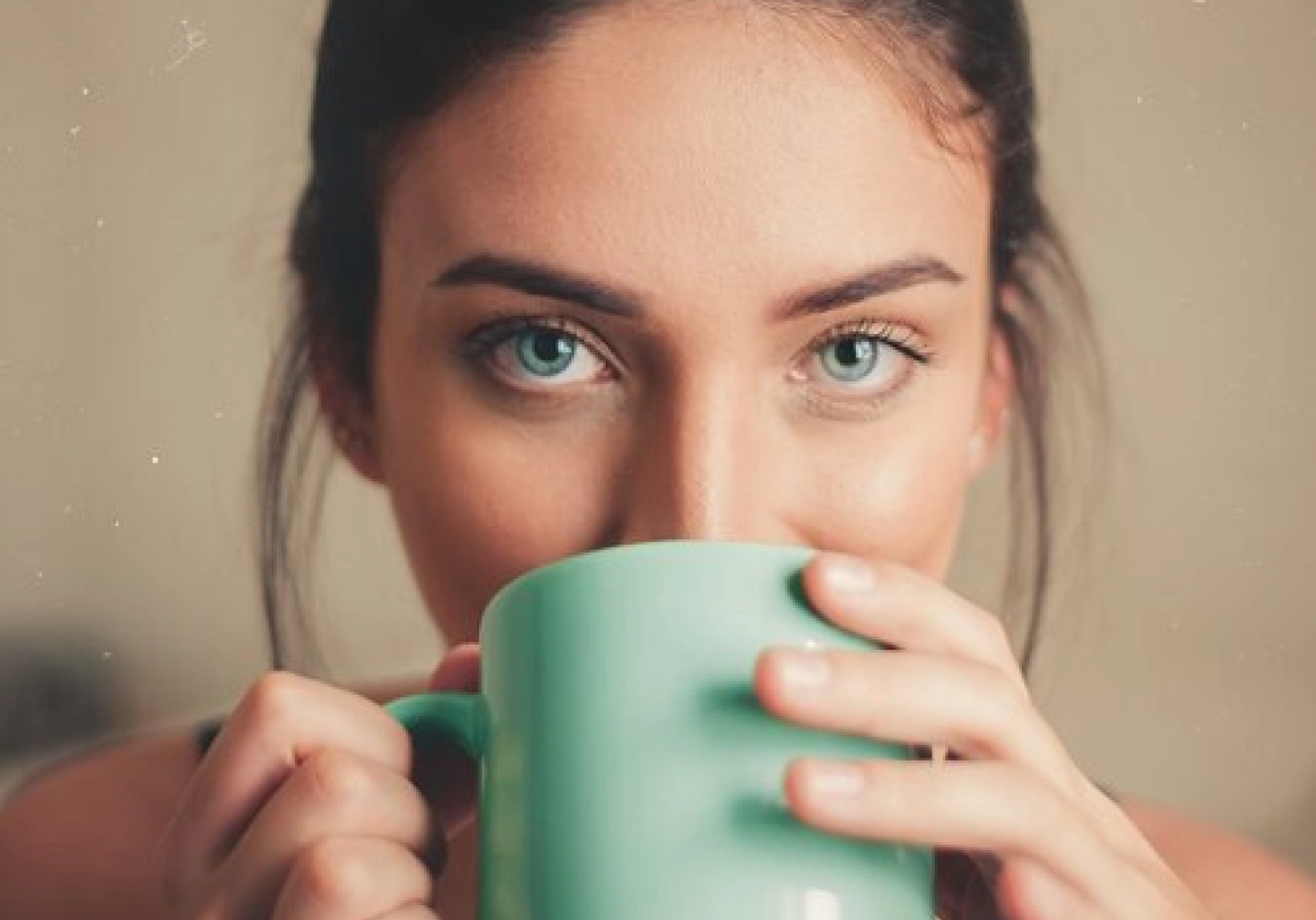 Woman drinks from a mug