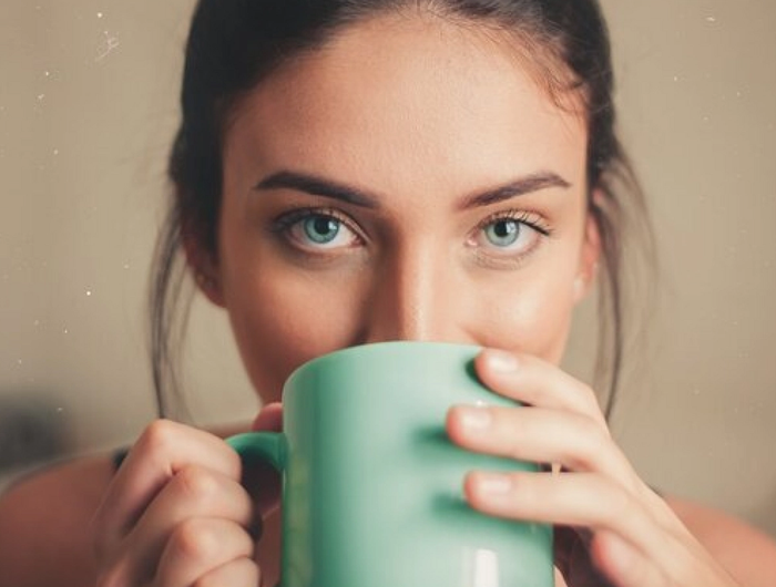 Woman drinks from a mug