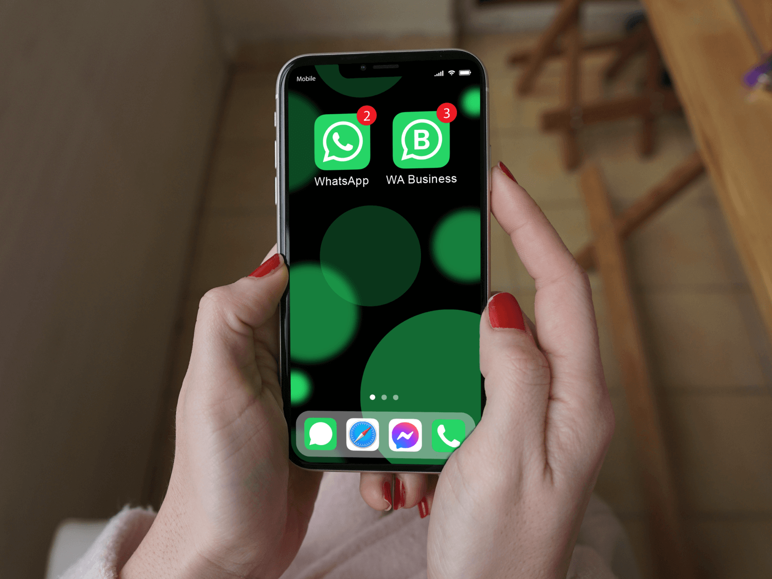 hands holding a phone with WhatsApp and WhatsApp Business installed on it