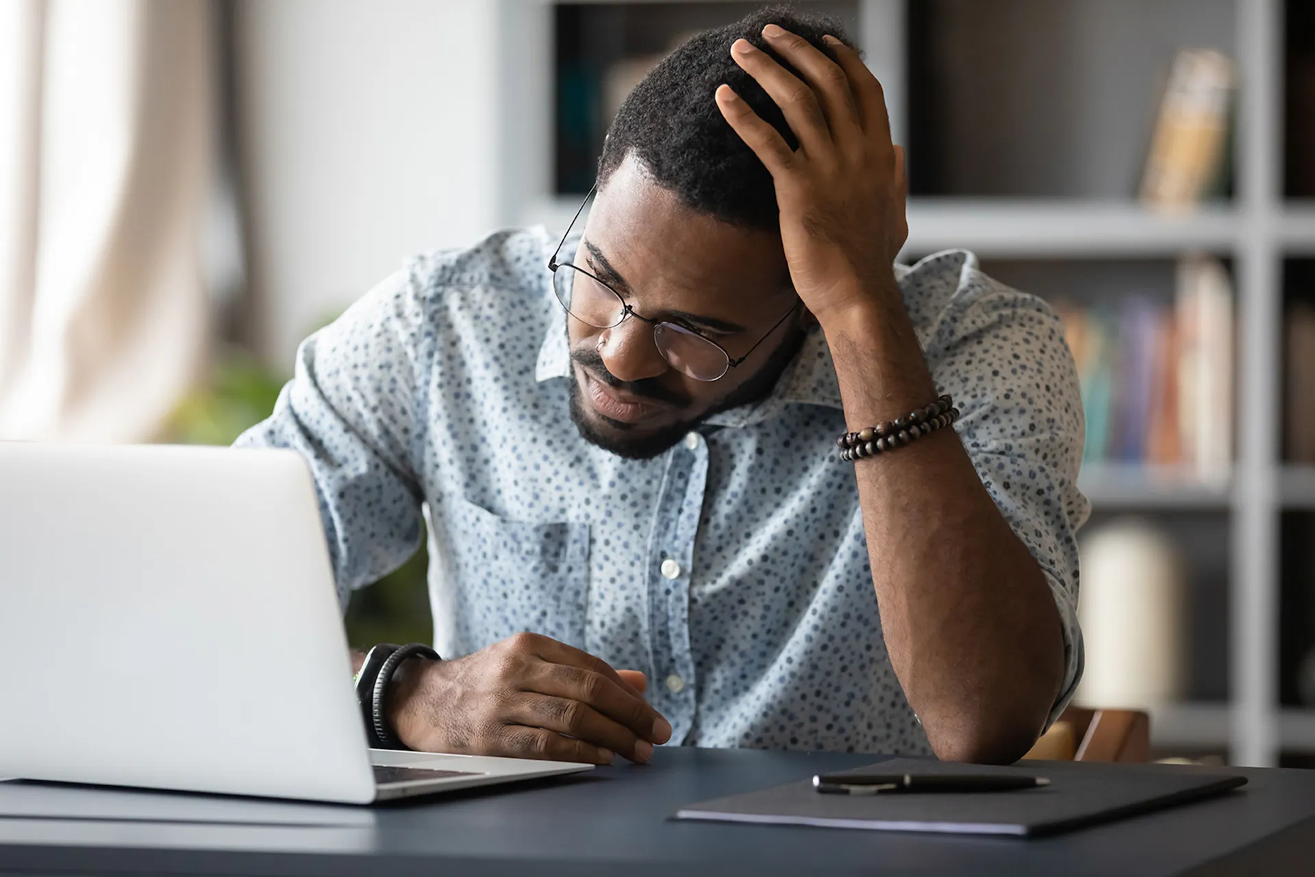Frustrated man stares at laptop