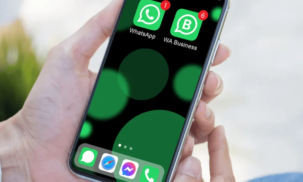 male hands holding a phone with WhatsApp and WhatsApp Business installed on it