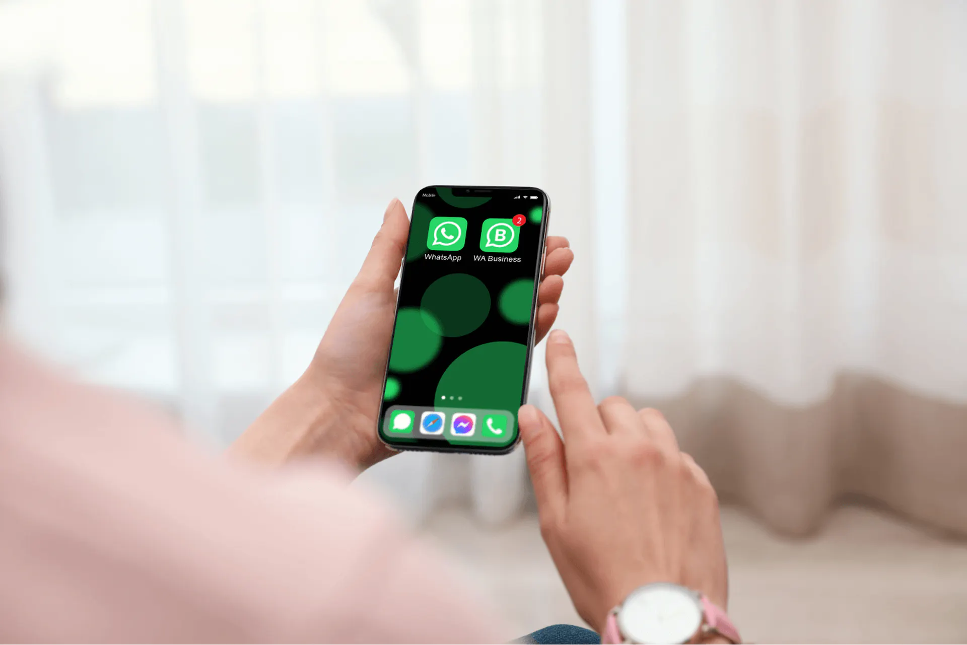 office worker hands holding a phone with WhatsApp and WhatsApp Business installed on it